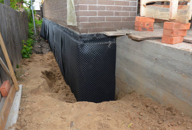 SJ Waterproofing Pros technician performing targeted Wet Basement Repair assessment in Waterville, WA